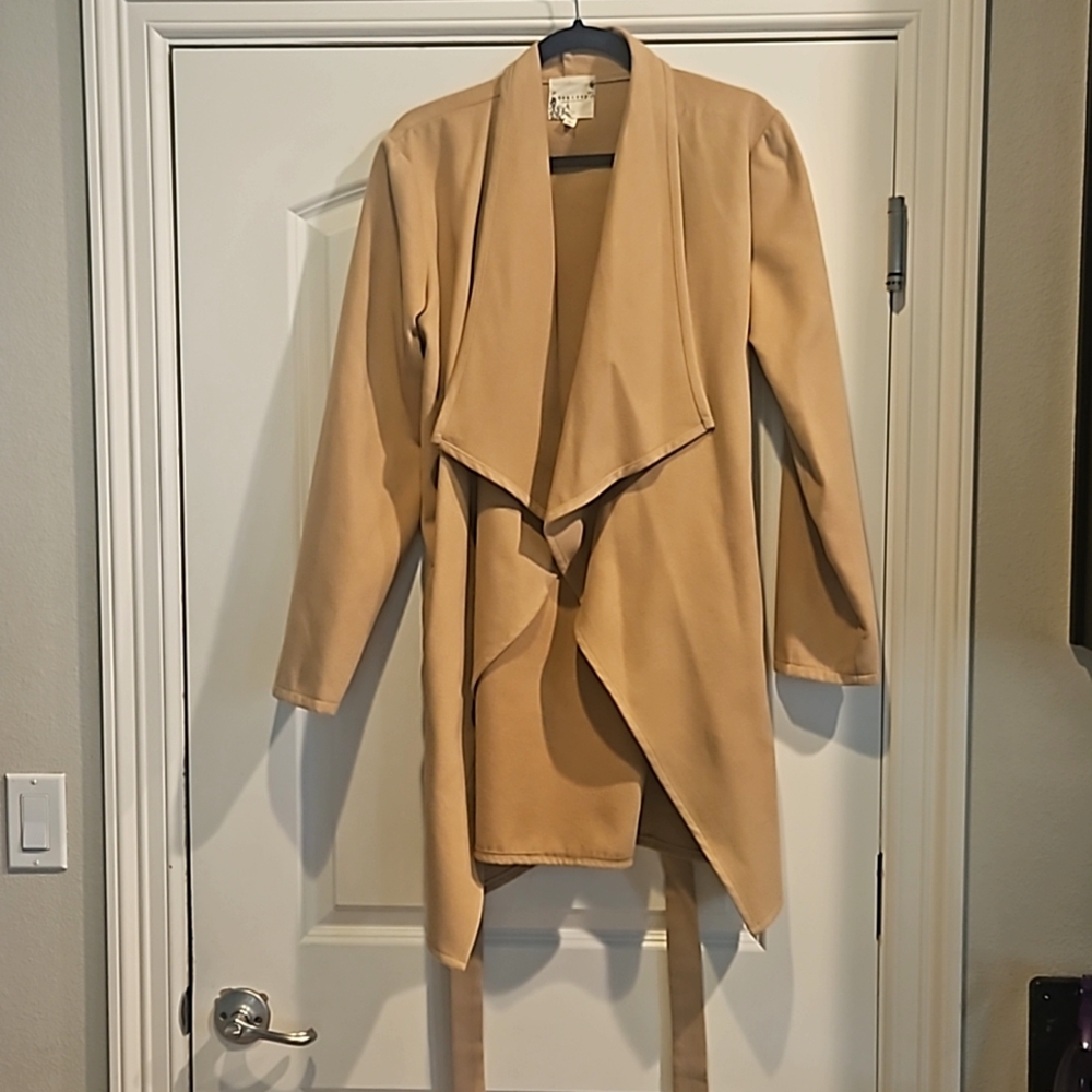 Wrap coat by tea and cup